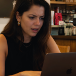 Mulher jovem consultando precatório online em laptop